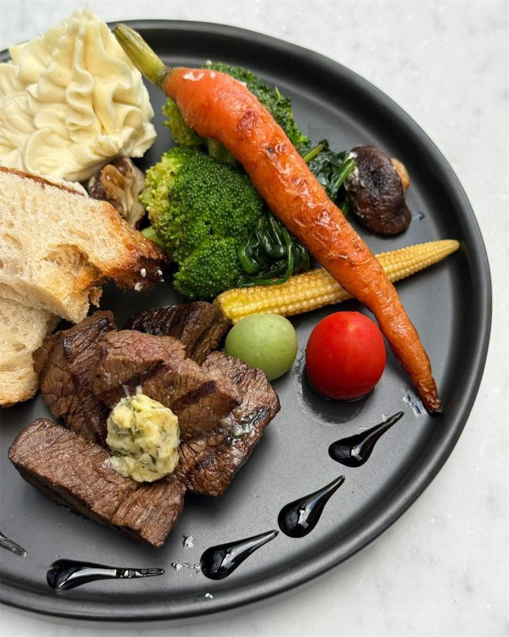 Plated grilled steak with seasonal vegetables
