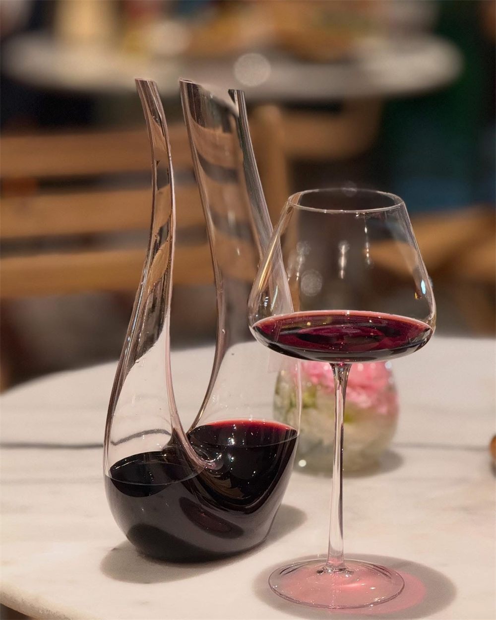 Red wine decanter and glass on a marble table