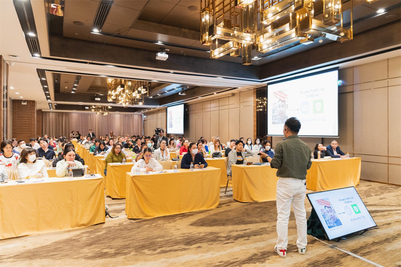 Speaking to a full seminar room about traffic and funnel systems